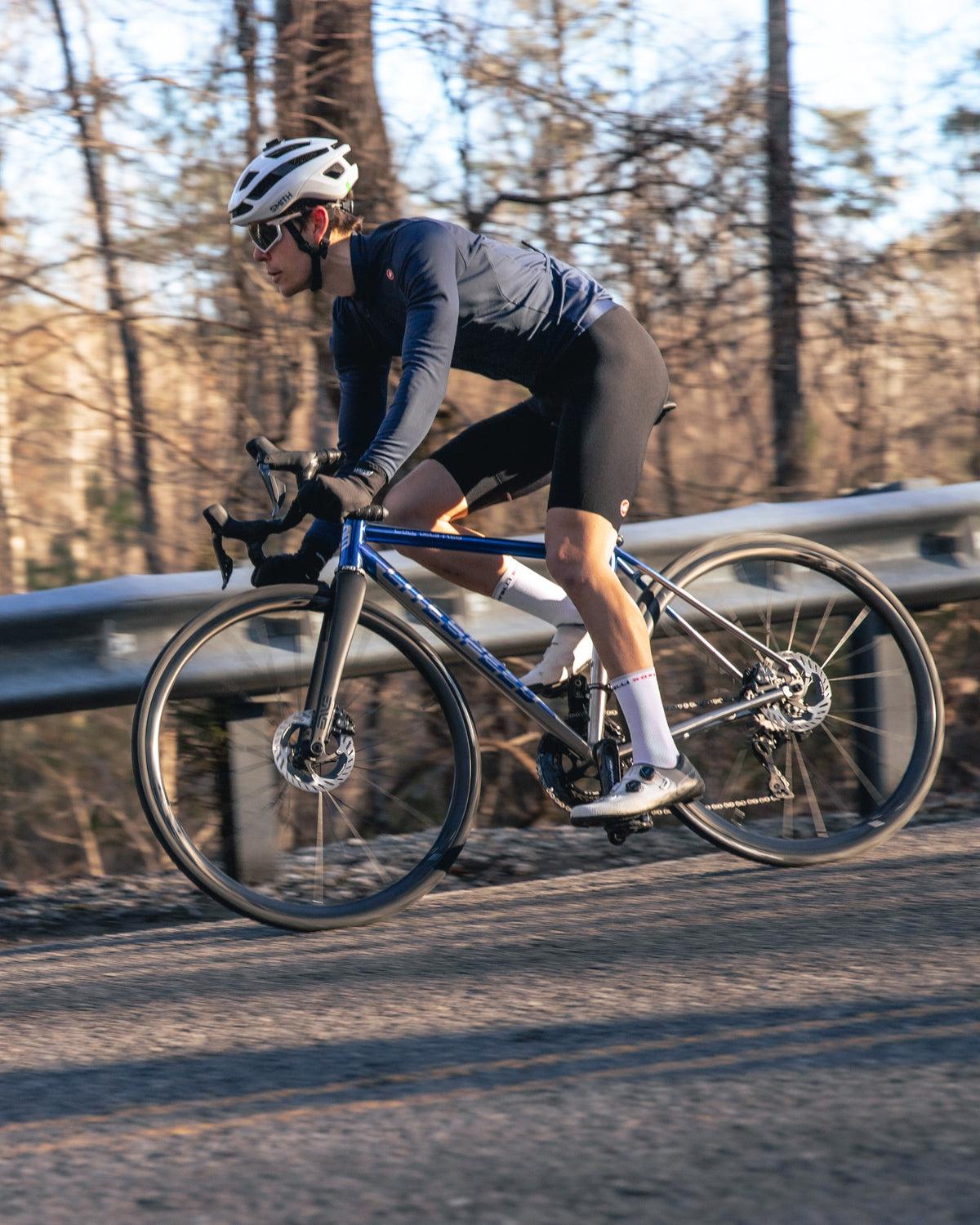 Cyclist on a road bike in a forested area