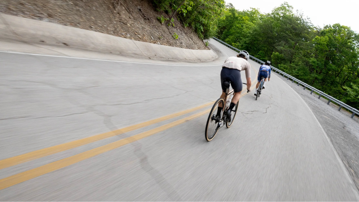 Two Road Riders Climbing on a Paved Road